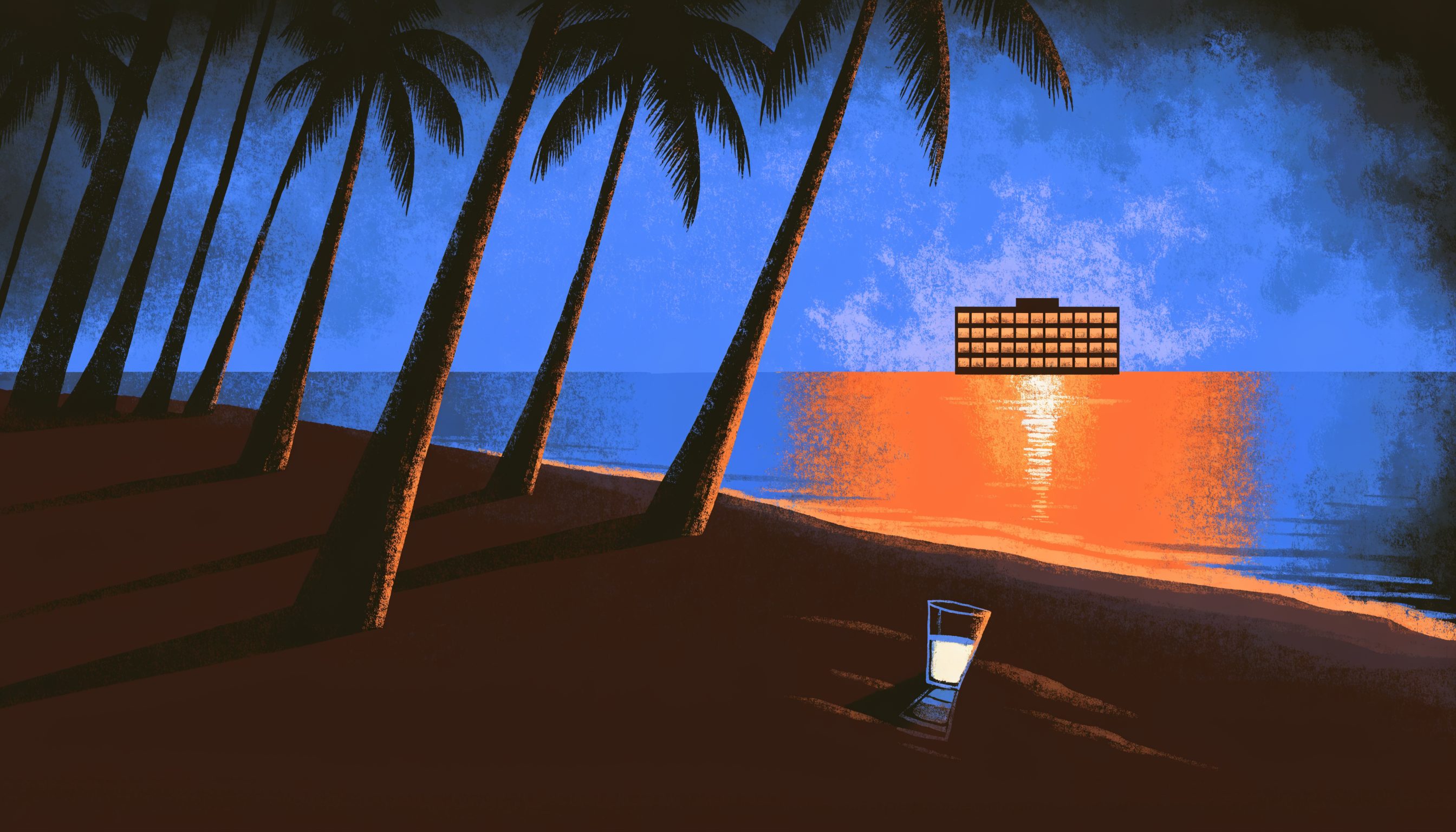 An empty sun lounge under palm trees at dusk, with a small office building glowing across the water.
